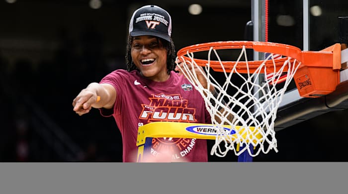 Virginia Tech forward Taylor Soule celebrates as she cuts off a piece of the net after beating Ohio State in the Elite Eight.